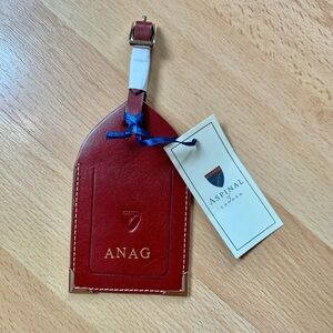 Aspinal of London luggage tag embossed brand new